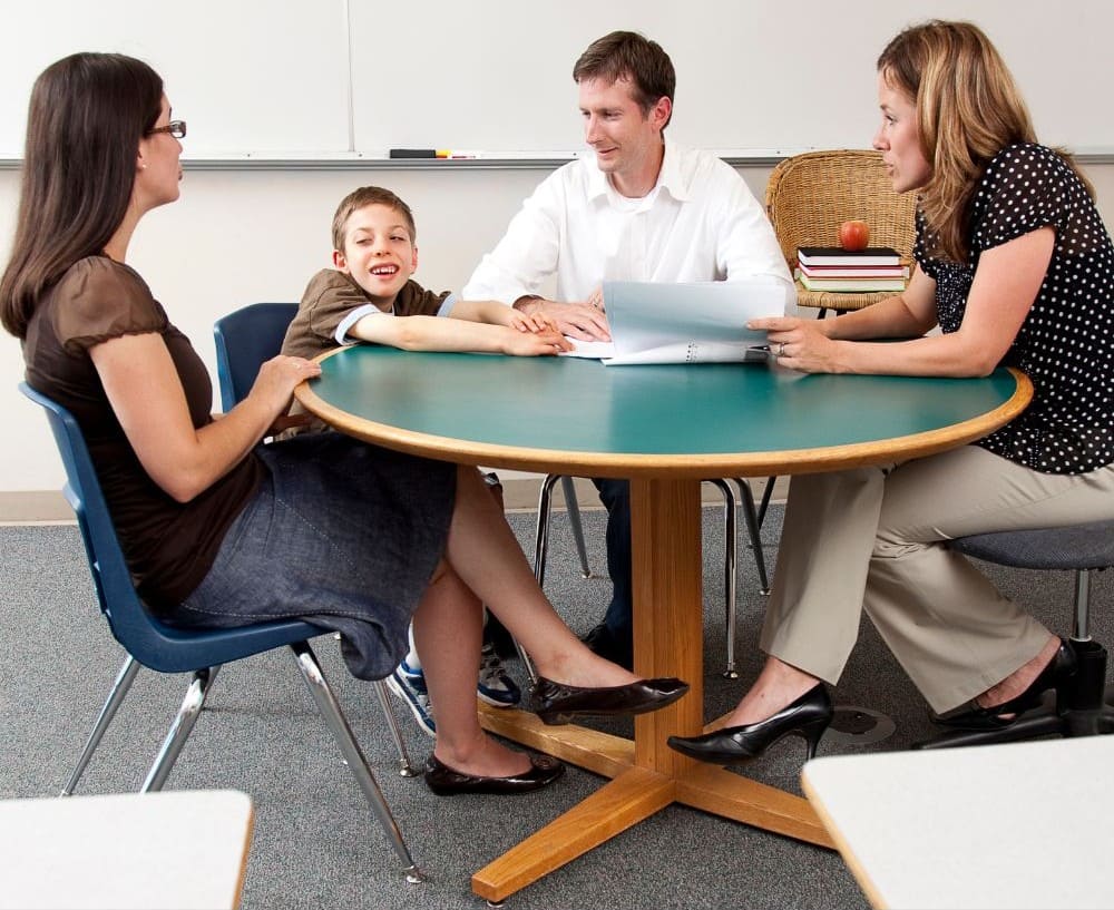 Parent advocating for IEP services at a school meeting for their autistic child